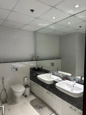a bathroom with two sinks and a toilet and a mirror at 2 Bedroom in Noora Tower, Fully furnished, Sea View in Dubai