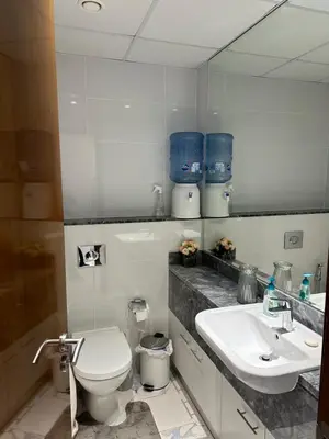 a white bathroom with a toilet and a sink at 2 Bedroom in Noora Tower, Fully furnished, Sea View in Dubai