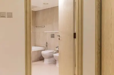 a bathroom with a toilet and a bath tub at Luxury stay Private Beach Access in Dubai