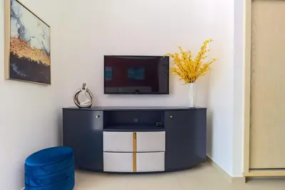 a blue cabinet with a tv on a wall at Luxury stay Private Beach Access in Dubai