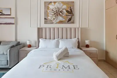 a bedroom with a bed with a prime forever sign on it at Sunny Studio Perfect For Discovery Gardens Stays in Dubai