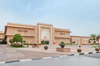 a large building with a courtyard in front of it at Sunny Studio Perfect For Discovery Gardens Stays in Dubai