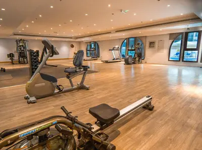 a gym with several exercise equipment in a room at EasyGo -Stylish STU With pool view Linkin park Arjan- 17 in Dubai