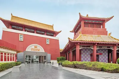a large red building with a building at Sunny Studio Perfect For Discovery Gardens Stays in Dubai