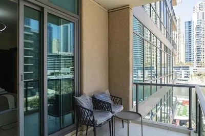 a balcony with two chairs and a table at Luxurious Waterfront at Al Majara Dubai Marina in Dubai