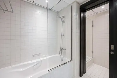a bathroom with a tub and a glass shower at Luxurious Waterfront at Al Majara Dubai Marina in Dubai