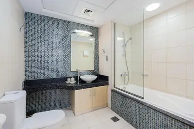 a bathroom with a toilet and a sink and a shower at DVH Al Hamri Jumeirah Shoreline 2 Bed & Maids Free beach access in Dubai