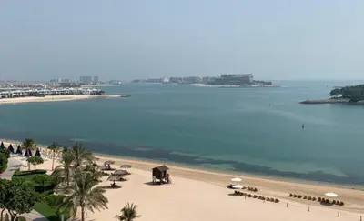 a view of a beach with umbrellas and the ocean at DVH Al Hamri Jumeirah Shoreline 2 Bed & Maids Free beach access in Dubai