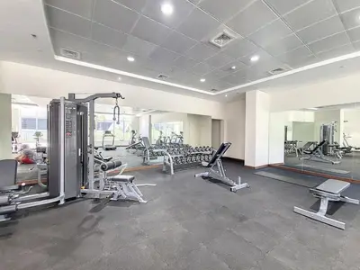 a gym with treadmills and machines in a room at Vacationer I Sophisticated 1 Bedroom Apartment I Steps from Dubai Mall & Burj Khalifa I Dunya Tower in Dubai