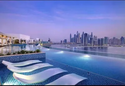a hotel swimming pool with a view of a city at Seven Hotel and Apartment - Chic Studio in the Palm in Dubai