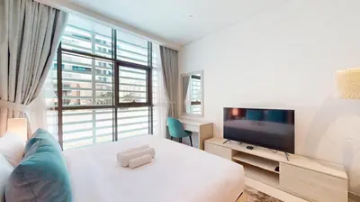 a hotel room with a bed and a television at Seven Hotel and Apartment - Chic Studio in the Palm in Dubai