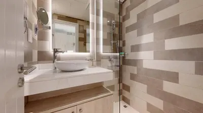 a bathroom with a sink and a mirror at Seven Hotel and Apartment - Chic Studio in the Palm in Dubai