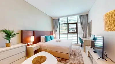 a hotel room with a bed and a desk at Seven Hotel and Apartment - Chic Studio in the Palm in Dubai