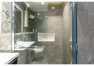 a bathroom with a shower with a sink and a mirror at Bright Resort Style Studio Amenities Samana GA by Vibel in Dubai