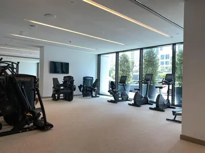 a gym with a bunch of exercise equipment in a room at Elegant Luxury Living in Palace Residences in Dubai