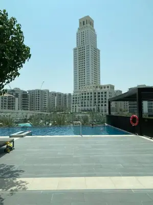 a large swimming pool in a city with tall buildings at Elegant Luxury Living in Palace Residences in Dubai