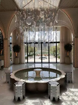 a large room with a large fountain and chandelier at Elegant Luxury Living in Palace Residences in Dubai