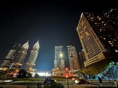 a city skyline at night with tall buildings at Canvas Partition Room in Barsha Heights Near Metro in Dubai