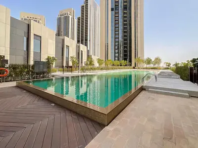 a swimming pool in a city with tall buildings at FAM Living - Spacious 3-Bedroom Apartment in Creek Gate with Stunning Views in Dubai