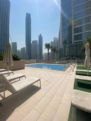 a swimming pool in a city with tall buildings at Superb 1Bed With Pool & Gym near the Burj Khalifa in Dubai