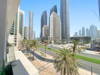 a view of a city with tall buildings and palm trees at Superb 1Bed With Pool & Gym near the Burj Khalifa in Dubai