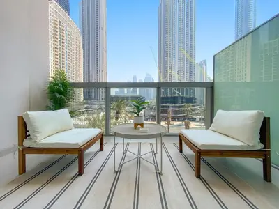a balcony with two chairs and a table on a building at Superb 1Bed With Pool & Gym near the Burj Khalifa in Dubai