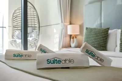 a hotel room with three pillows on a bed at Superb 1BR Apartment in the Heart of Business Bay in Dubai