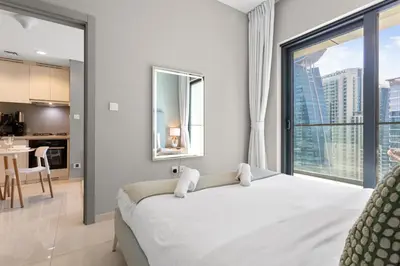a bedroom with a large bed and a large window at Superb 1BR Apartment in the Heart of Business Bay in Dubai