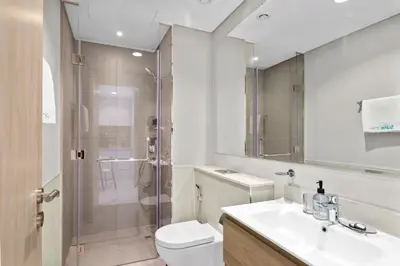 a bathroom with a shower and a toilet and a sink at Superb 1BR Apartment in the Heart of Business Bay in Dubai