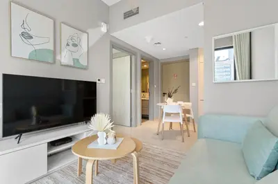 a living room with a couch and a tv and a table at Superb 1BR Apartment in the Heart of Business Bay in Dubai
