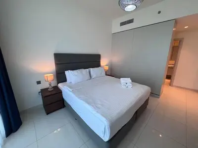 a bedroom with a bed with two towels on it at 2 Bed - Sunrise Bay Views in Dubai