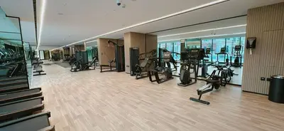 a gym with treadmills and exercise equipment in a building at Comfortable 1br Stay In Jvc Parking & Pool in Dubai