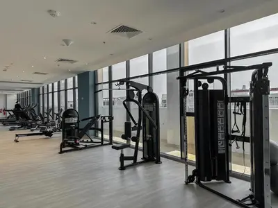 a gym with a row of treadmills and machines at Royalton - Serene Studio Apt in the Heart of Meydan District in Dubai