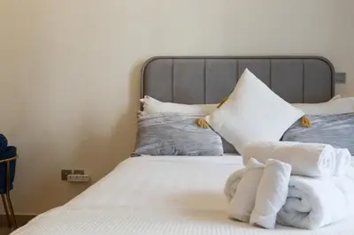 a bedroom with a bed with towels on it at Royalton - Serene Studio Apt in the Heart of Meydan District in Dubai