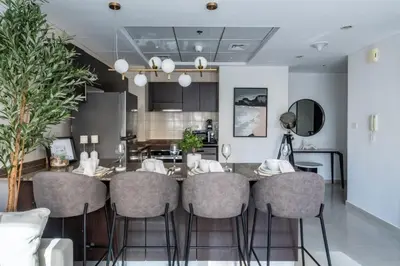 a kitchen and dining room with a table and chairs at GuestReady - Lux home amid Dubai Marina and JBR in Dubai