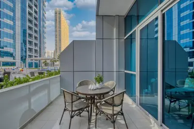 a table and chairs on a balcony with a view of the city at GuestReady - Lux home amid Dubai Marina and JBR in Dubai