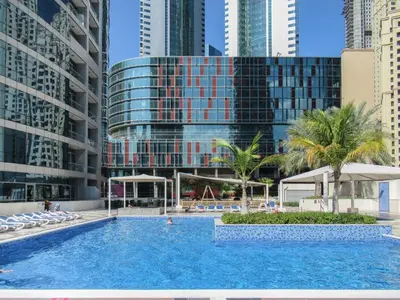 a swimming pool in a city with tall buildings at GuestReady - Lux home amid Dubai Marina and JBR in Dubai