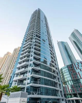 a tall building with glass windows in a city at GuestReady - Lux home amid Dubai Marina and JBR in Dubai