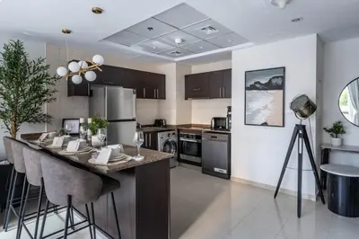 a kitchen with a large island with bar stools at GuestReady - Lux home amid Dubai Marina and JBR in Dubai