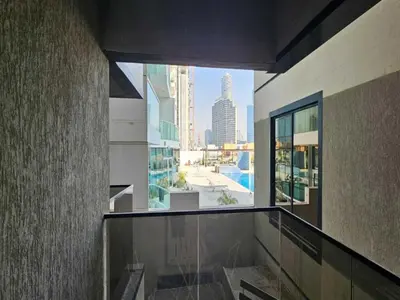 a balcony of a building with a view of a city at Luxury Studio in Jumeirah Village Circle in Dubai
