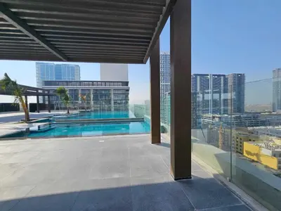a view of a swimming pool on top of a building at Luxury Studio in Jumeirah Village Circle in Dubai