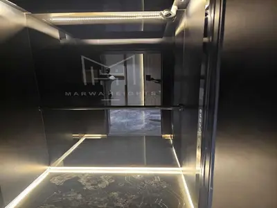 an empty refrigerator with a glass door and a window at Luxury Studio in Jumeirah Village Circle in Dubai
