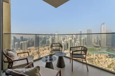 a balcony with chairs and a view of the city at Full Fountain and Burj View - 3BR Burj Royale in Dubai