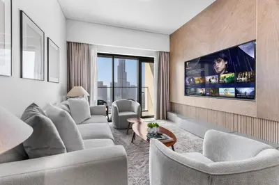 a living room with couches and a flat screen tv at Full Fountain and Burj View - 3BR Burj Royale in Dubai