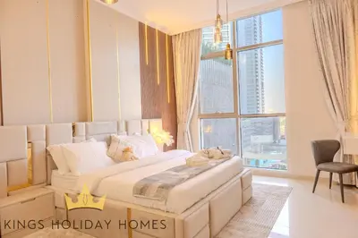 a bedroom with a large bed and a large window at Royal suites Dunya tower Burj Khalifa St Kings in Dubai