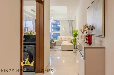 a living room with a washer and dryer at Royal suites Dunya tower Burj Khalifa St Kings in Dubai