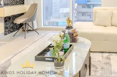 a living room with a white couch and a glass coffee table at Royal suites Dunya tower Burj Khalifa St Kings in Dubai