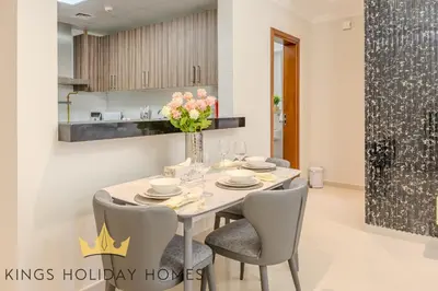 a dining room with a table and chairs at Royal suites Dunya tower Burj Khalifa St Kings in Dubai