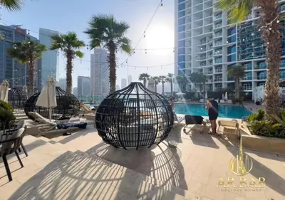 a group of bird cages sitting next to a pool at Damac Maison Prive - Luxury Studio - Burj Khalifa View in Dubai