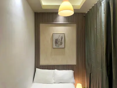 a bedroom with a bed and a picture on the wall at Pathfinder Partition Room in Barsha Heights Tecom in Dubai